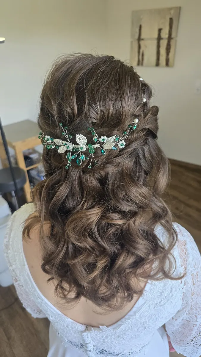 Halboffene Brautfrisur mit Blütenranke zum Boho-Brautkleid